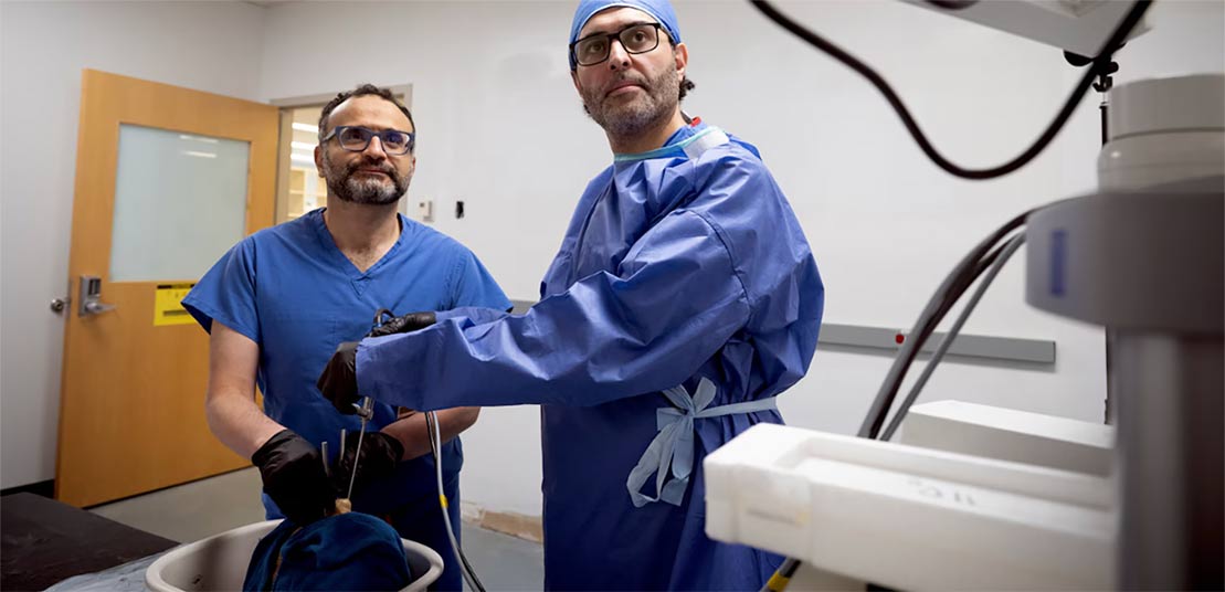 Two UMB surgeons remove a tumor through the patient's eye socket.