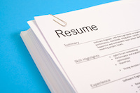 a stack of resumes against a blue background