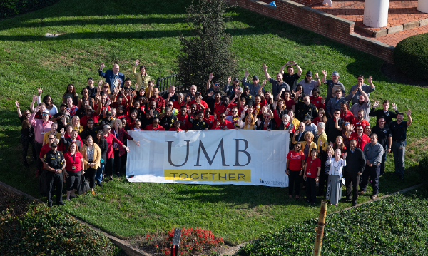 faculty and staff smiling and waving