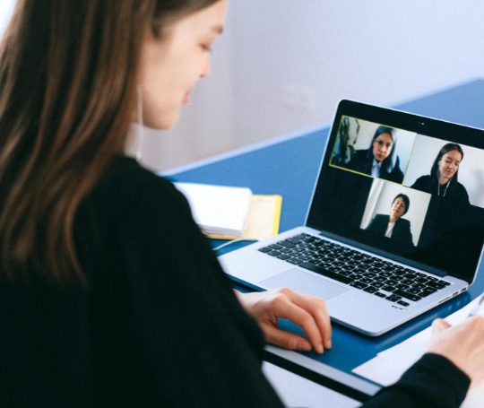 A woman looking at Zoom on a laptop