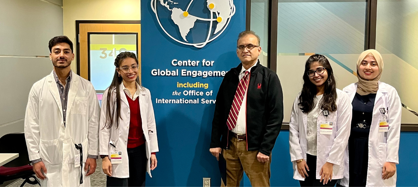 Medical students from Pakistan pose with a doctor.