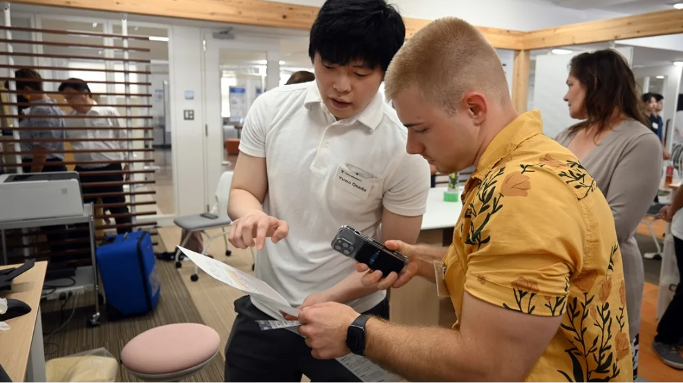 A Japanese and UMB student examine medical equipment