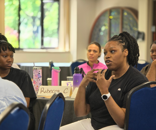 A woman talks in a group setting