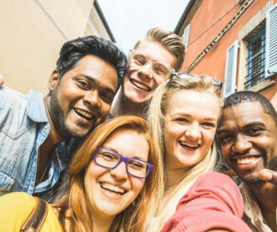 A group of people pose for a selfie