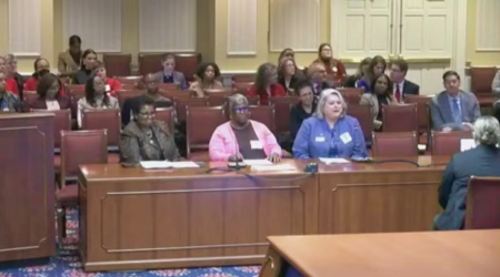 UMSSW Dean Judy Postmus, right, testifies in front of the Maryland Senate Finance Committee.