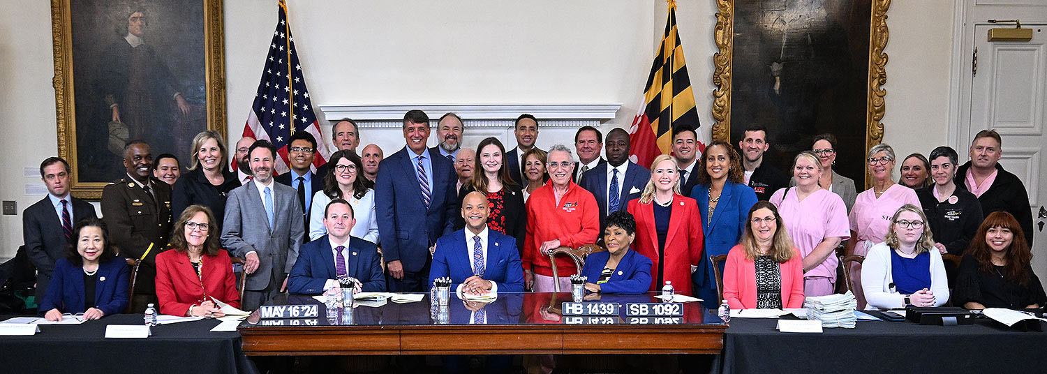 Gov. Wes Moore, Senate President Bill Ferguson, and House Speaker Adrienne Jones were supported by Shock Trauma team members, survivors, and supporters as they signed Senate Bill 1092 and House Bill 1439 on May 16.