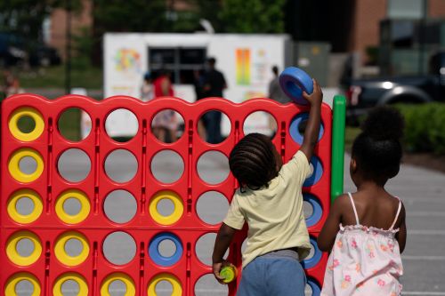 Kids gather for a friendly round of giant Connect 4 at the Juneteenth celebration.