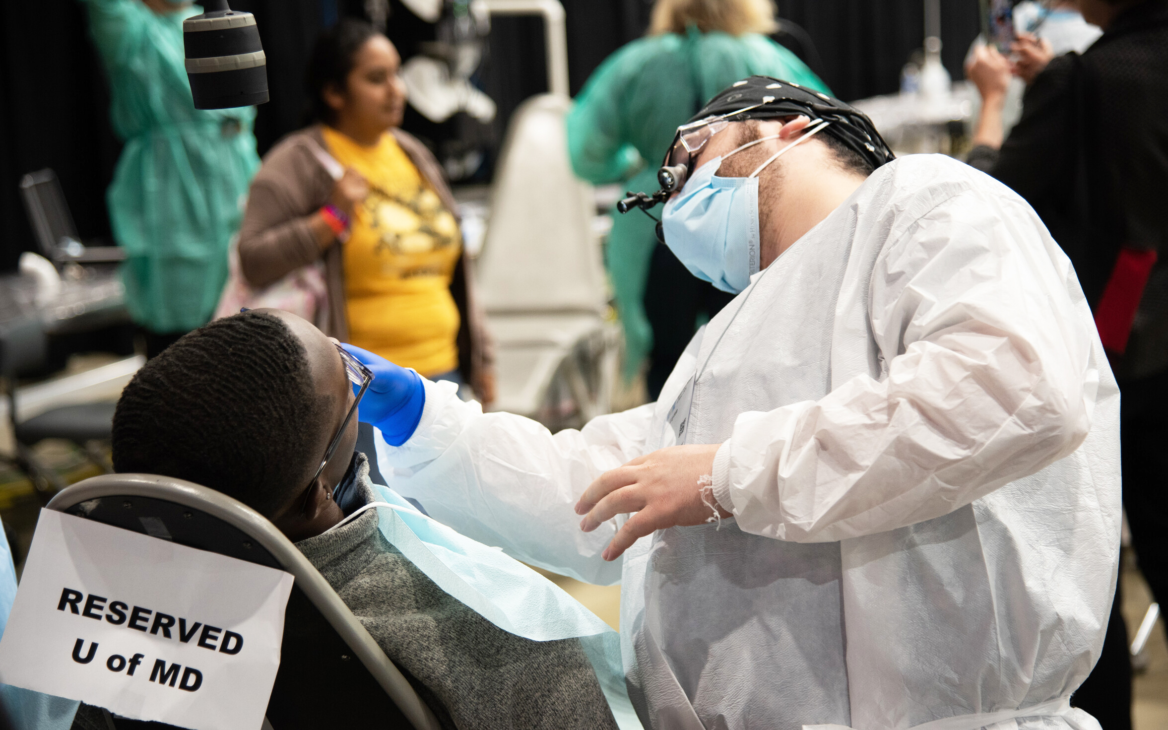 Andrew Layton, DDS, examines a patient at the Eastern Shore Mission of Mercy.