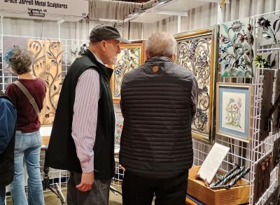 President Jarrell discusses his metalwork with a visitor during the Philadelphia Museum of Art's Contemporary Craft Show.