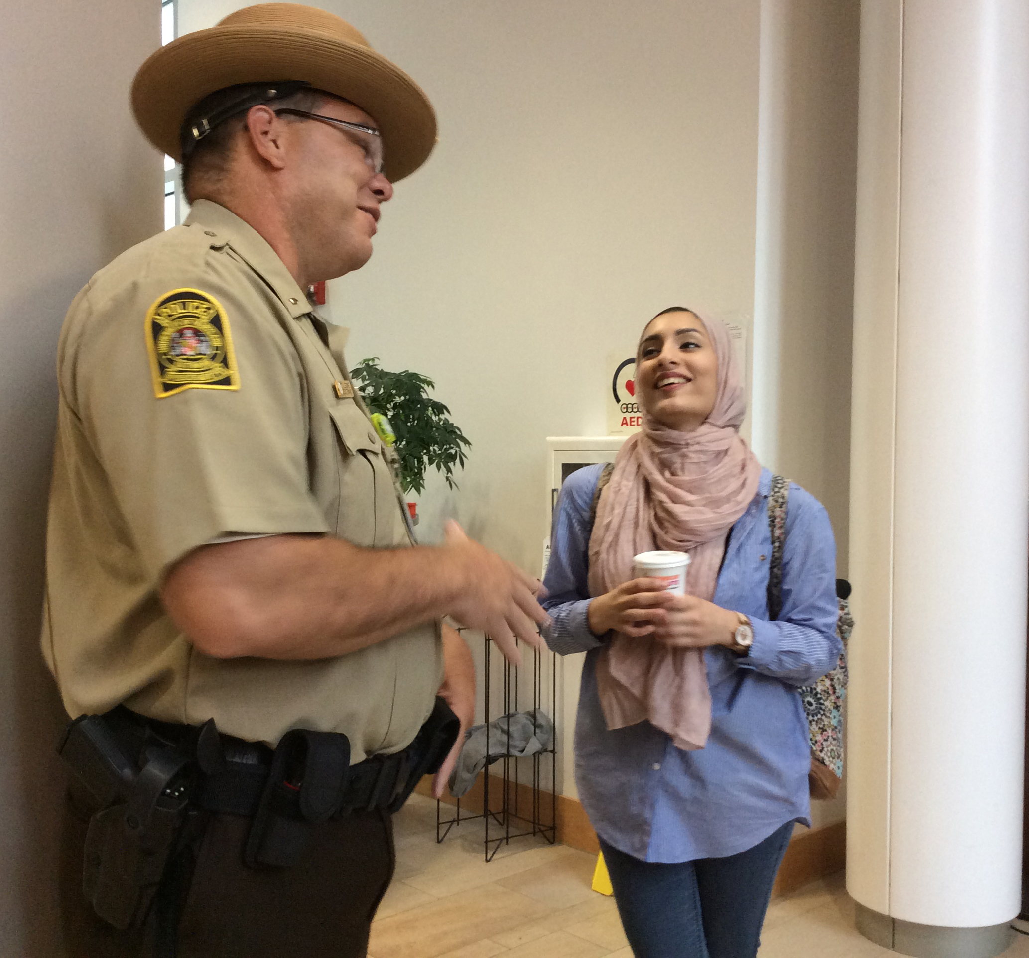 Lt. Thomas Leone and School of Pharmacy student Saniya Chaudhry chat at 