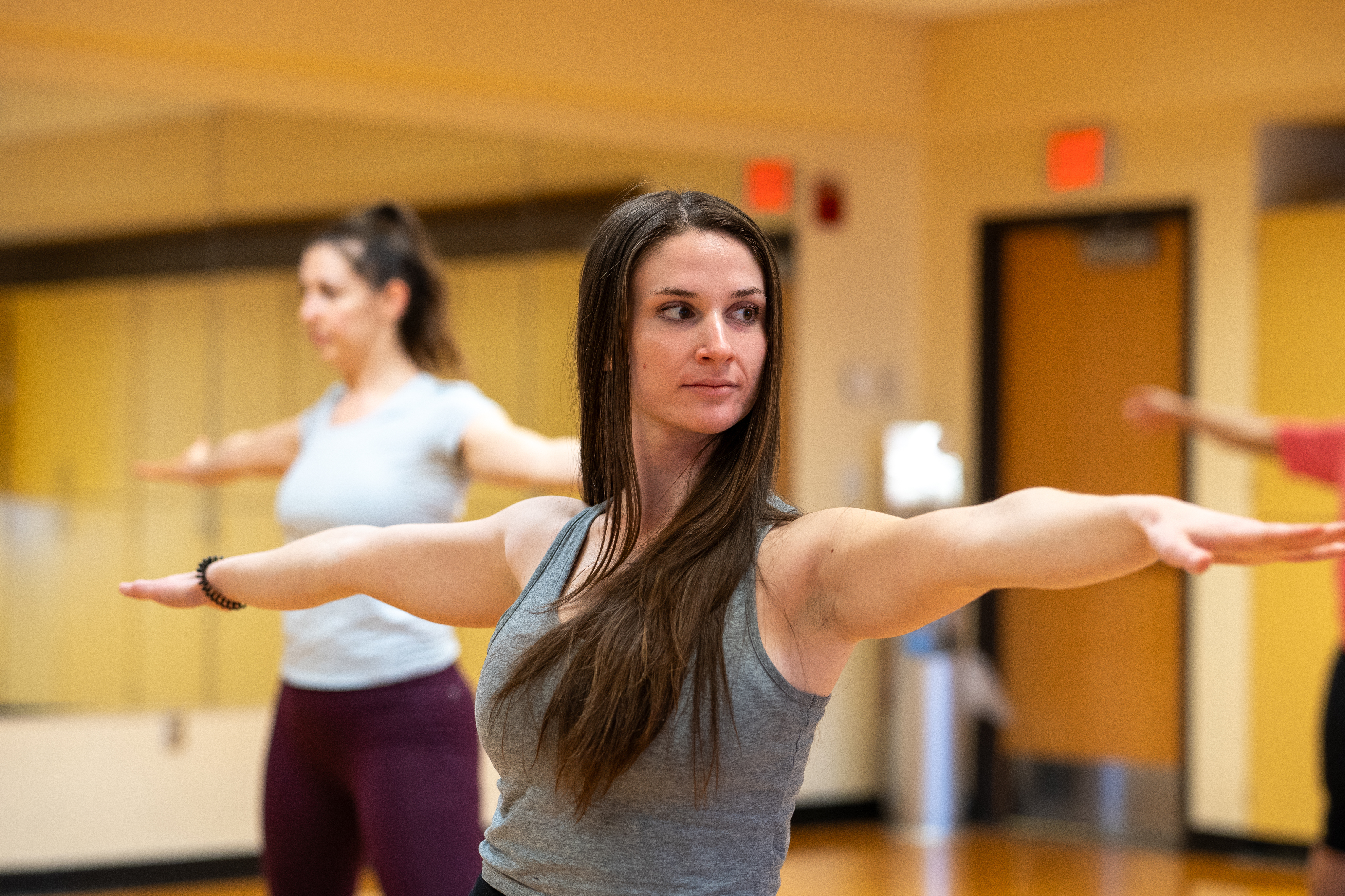 female performing warrior yoga pose