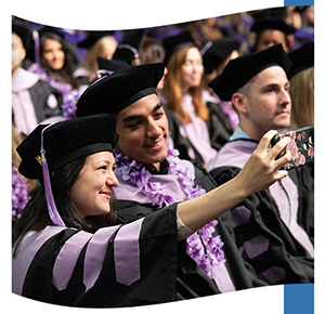 Two people taking a photo at graduation